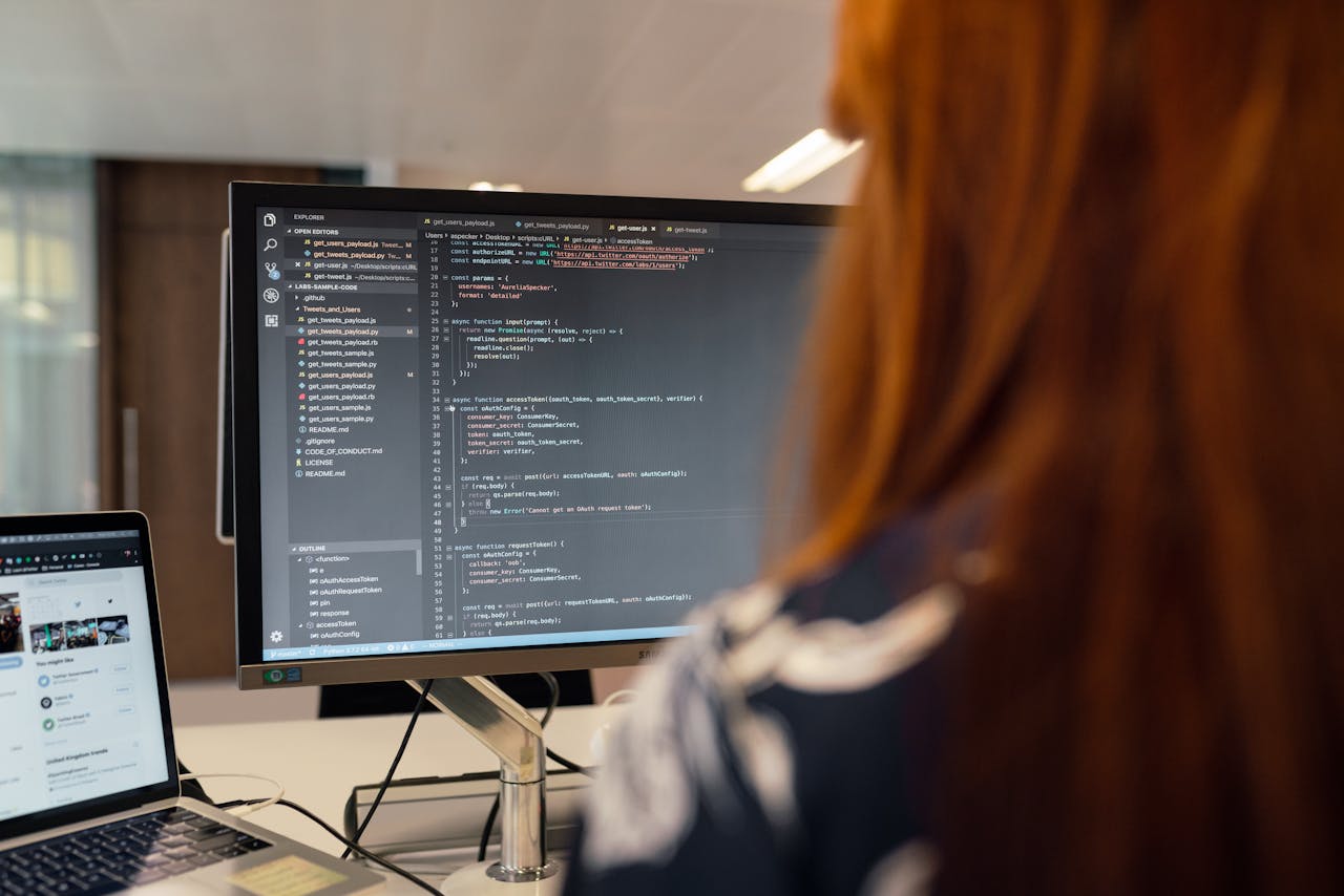 A female engineer works on code in a contemporary office setting, showcasing software development.